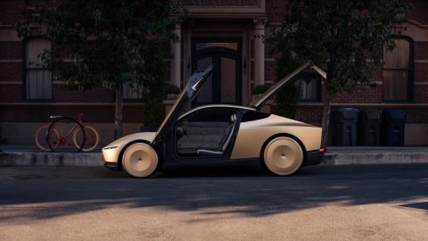 Altın renkli, direksiyonsuz iki kişilik Tesla Cybercab